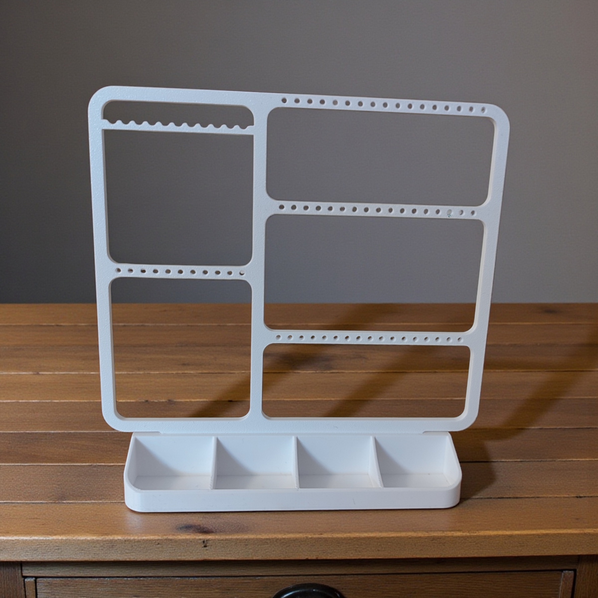 Minimalistische sieradenhouder met oorbellen, ringen en kettingen in strak wit design