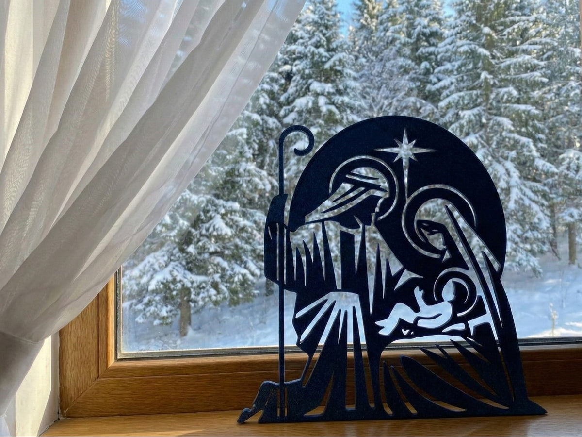 Kerststal als silhouet met Jozef, Maria, het kindje Jezus en ster