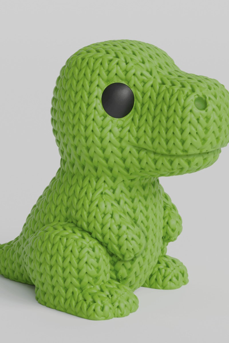 Close-up van een gebreid T-Rex-figuurtje in saliegroen met gehaakte look