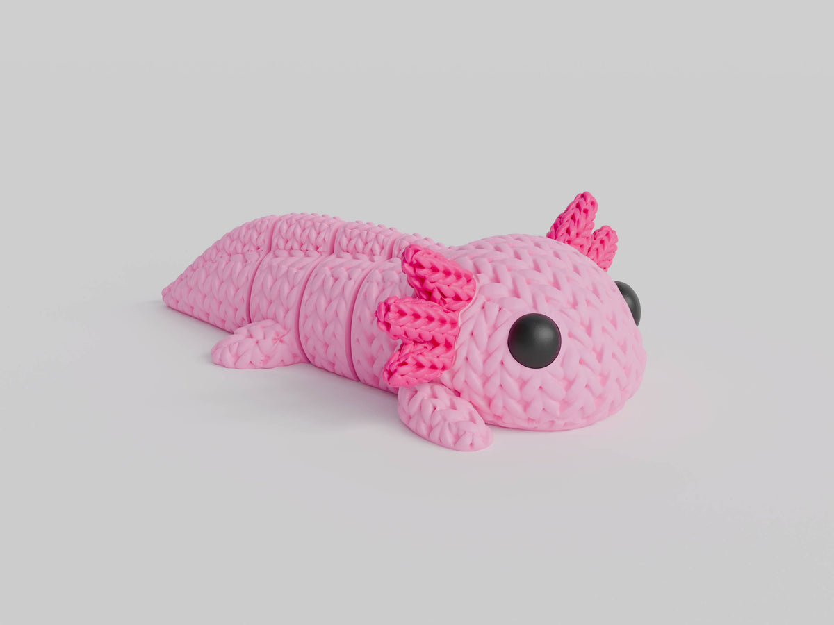 Close-up van een gebreid axolotlfiguurtje in roze met gehaakte textuur