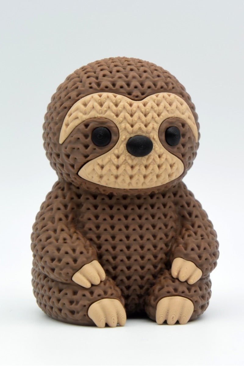Close-up van een gebreid luiaardfiguurtje met gehaakte look in warme kleuren, ca. 10 cm