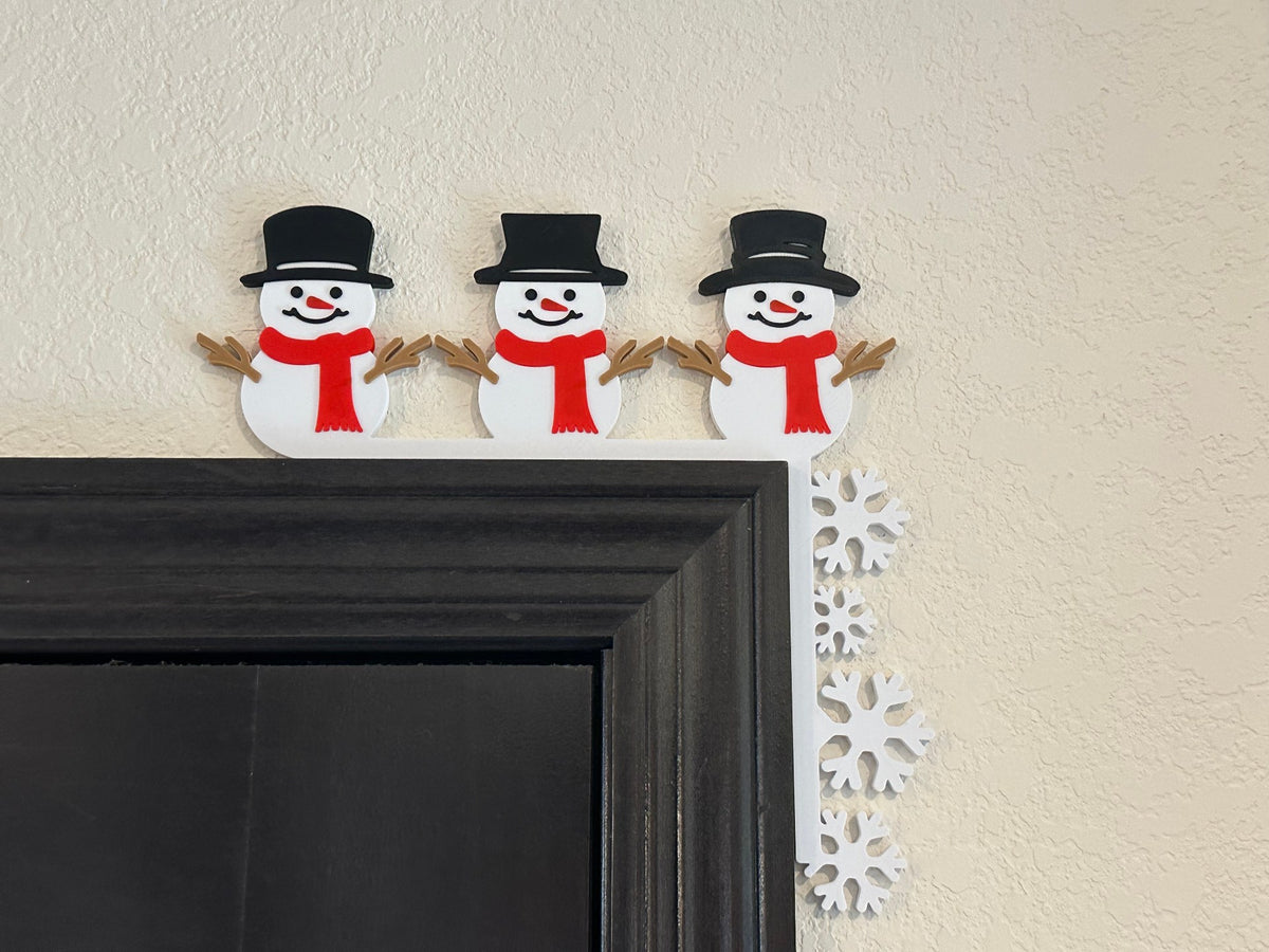Sneeuwpoppen en sneeuwvlokken als decoratie in de hoek van de deurpost